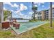 Scenic outdoor shuffleboard court with seating and nearby lake and community building at 3521 Lake Bayshore Dr # 3521, Bradenton, FL 34205