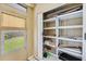 Storage space with shelving units, closet doors, and a window to the backyard at 3521 Lake Bayshore Dr # 3521, Bradenton, FL 34205