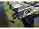 A bird's eye view of homes along a lake, with a pool and screened in lanai at 3631 Shimmering Oaks Dr, Parrish, FL 34219
