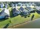 Expansive aerial view of the property showcasing its large backyard, screened-in lanai, and serene lake view at 3631 Shimmering Oaks Dr, Parrish, FL 34219
