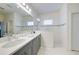 Modern bathroom with double sinks, a large mirror, and a glass-enclosed shower at 3631 Shimmering Oaks Dr, Parrish, FL 34219