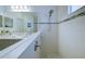 Bathroom showcasing a dual vanity, a seamless shower, and decorative tile accents at 3631 Shimmering Oaks Dr, Parrish, FL 34219