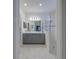 Primary bathroom with double vanity, a glass shower, and marble floors at 3631 Shimmering Oaks Dr, Parrish, FL 34219
