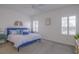 Bright bedroom featuring a blue bedframe, neutral walls, and shuttered windows at 3631 Shimmering Oaks Dr, Parrish, FL 34219