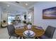 Dining area with a round wood table set for four, open to the kitchen and living area at 3631 Shimmering Oaks Dr, Parrish, FL 34219