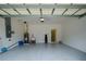 Spacious garage with epoxy flooring, a utility sink, and an insulated garage door at 3631 Shimmering Oaks Dr, Parrish, FL 34219