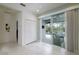 Hallway features views of the screened-in pool through the sliding glass doors at 3631 Shimmering Oaks Dr, Parrish, FL 34219
