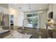 Modern kitchen with stainless steel appliances, granite counters, view to the pool, and ample cabinet space at 3631 Shimmering Oaks Dr, Parrish, FL 34219