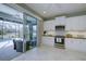 Modern kitchen with stainless steel appliances, marble floors and a view of the screened in pool and patio at 3631 Shimmering Oaks Dr, Parrish, FL 34219