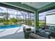 Enclosed patio featuring a luxurious pool and scenic water views at 3631 Shimmering Oaks Dr, Parrish, FL 34219