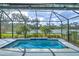 Relaxing screened-in pool with a tranquil water view at 3631 Shimmering Oaks Dr, Parrish, FL 34219