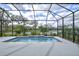 Screened in pool with a tile border and a water feature and a nice view at 3631 Shimmering Oaks Dr, Parrish, FL 34219