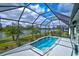 Sparkling screened in pool with beautiful lake view and a large deck area at 3631 Shimmering Oaks Dr, Parrish, FL 34219
