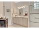 This bathroom features tile flooring, double sinks, a shower, and a glass block window at 3804 Amapola Ln, Sarasota, FL 34238