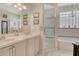 This bathroom features tile flooring, double sinks, a shower, and a soaking tub at 3804 Amapola Ln, Sarasota, FL 34238