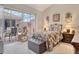 This bedroom features carpet, a sliding glass door to the outdoor patio, and a rocking horse at 3804 Amapola Ln, Sarasota, FL 34238