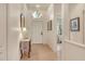 Inviting foyer with tiled floor, transom window, and decorative console table at 3804 Amapola Ln, Sarasota, FL 34238