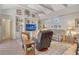 Cozy living room with vaulted ceilings, built-in shelves, and a ceiling fan at 3804 Amapola Ln, Sarasota, FL 34238
