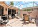 A well-appointed screened patio with seating and grill offers outdoor relaxation at 3804 Amapola Ln, Sarasota, FL 34238