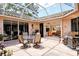 Outdoor patio seating area with grill and sliding doors to indoor living room at 3804 Amapola Ln, Sarasota, FL 34238