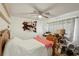 Bright bedroom with a ceiling fan, and a small desk with various items on it at 3881 Holin Ln, North Port, FL 34287