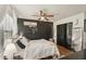 Charming bedroom featuring an accent wall, soft lighting, and ample space at 3881 Holin Ln, North Port, FL 34287