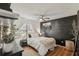 Comfortable bedroom with a black accent wall and ceiling fan at 3881 Holin Ln, North Port, FL 34287