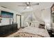 Bedroom with white curtains, a black dresser and a ceiling fan at 3881 Holin Ln, North Port, FL 34287