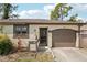 Close-up of home showcasing a welcoming front door, attached garage, and neat landscaping at 3881 Holin Ln, North Port, FL 34287