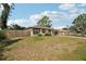 Inviting home with a fenced front yard, mature trees, and a classic suburban street view at 3881 Holin Ln, North Port, FL 34287