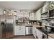 Well-lit kitchen boasts stainless steel appliances, granite countertops, and ample storage space at 3881 Holin Ln, North Port, FL 34287