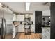 Contemporary kitchen with white cabinetry, stainless steel appliances, and efficient layout at 3881 Holin Ln, North Port, FL 34287