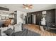 Comfortable living room with stylish black accent wall, wood-look flooring, and modern furnishings at 3881 Holin Ln, North Port, FL 34287