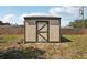 Outdoor shed with a decorative front door and ample yard space at 3881 Holin Ln, North Port, FL 34287