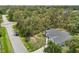 Aerial view of gray single-story home on lot surrounded by lush trees at 4091 Dull St, North Port, FL 34286