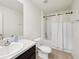 Clean, bright bathroom featuring a single sink vanity, toilet, and shower-tub combination at 4091 Dull St, North Port, FL 34286