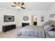 Comfortable bedroom features a large bed, neutral decor, and a ceiling fan at 4091 Dull St, North Port, FL 34286