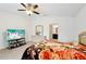 Bright bedroom with ceiling fan, mounted TV, and ensuite bathroom access at 4091 Dull St, North Port, FL 34286