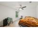 Cozy bedroom with ceiling fan, window with blinds, and simple furnishings at 4091 Dull St, North Port, FL 34286