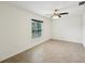 Clean bedroom with tile floors, ceiling fan, and a window to let in natural light at 4091 Dull St, North Port, FL 34286
