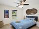 Cozy bedroom features a comfortable bed, ceiling fan, and ample natural light at 4091 Dull St, North Port, FL 34286