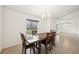 Cozy dining room with a wooden table, seating for six, and ample natural light at 4091 Dull St, North Port, FL 34286