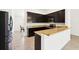 Modern kitchen featuring dark cabinets, granite countertops, and stainless steel appliances at 4091 Dull St, North Port, FL 34286