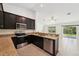 Modern kitchen features stainless steel appliances, granite countertops, and ample cabinet space at 4091 Dull St, North Port, FL 34286
