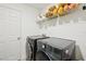 Modern laundry room with new washer and dryer, as well as wire shelving at 4091 Dull St, North Port, FL 34286