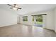 Bright and open living space with tiled floors and sliding glass doors to the backyard at 4091 Dull St, North Port, FL 34286