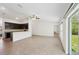 Open concept living area with breakfast bar, dark cabinetry, and access to outdoor space at 4091 Dull St, North Port, FL 34286