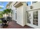View of the back deck, showing seating area and entry to the house via french doors at 4108 Roberts Point Rd, Sarasota, FL 34242