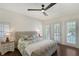 Serene bedroom featuring french doors to pool area and a decorative ceiling fan at 4108 Roberts Point Rd, Sarasota, FL 34242