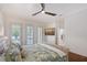 Bedroom with hardwood floors, plantation shutters, and access to an outdoor area at 4108 Roberts Point Rd, Sarasota, FL 34242